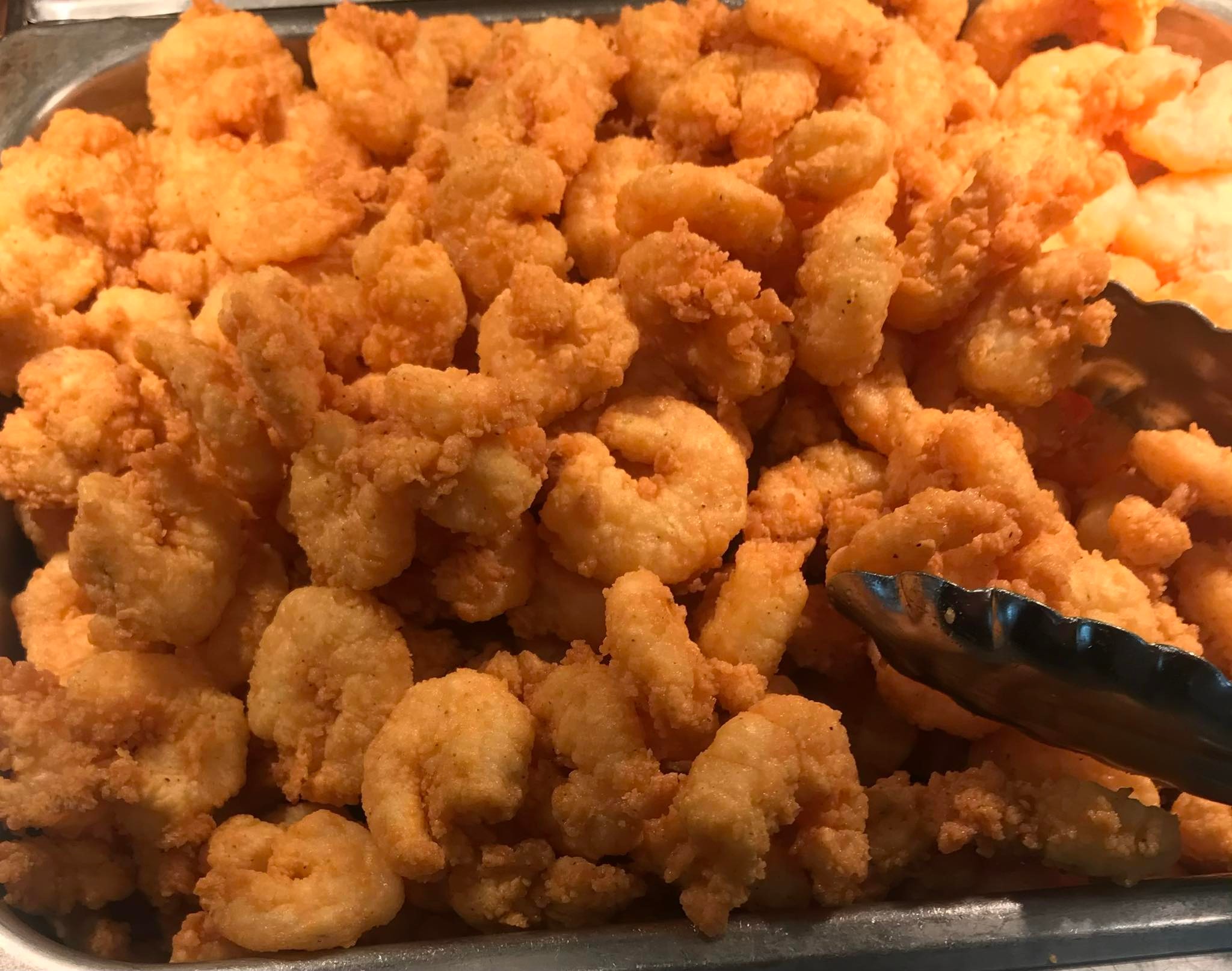 A heaping metal tray of golden-brown fried shrimp at Bourne's Restaurant